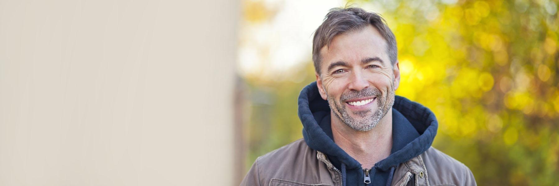 Man with facial hair smiling l dental implants farmington nm